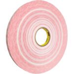 A large roll of 1/2 x 1000 yds. 3M™ 920XL Adhesive Transfer Tape, featuring a yellow core, is neatly rolled with adhesive layers against a white background. Available in cases of 12 rolls.