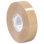 A 1/2 x 36 yds. (6 Pack) roll of glossy brown packing tape with a white plastic core sits against a white background, featuring a reflective finish akin to the 3M™ 987 Adhesive Transfer Tape.