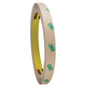 A 1/2 x 60 yds. (2 Pack) 3M™ F9465PC Adhesive Transfer Tape Hand Roll stands upright against a white background, featuring a beige surface with green 3M logos and a yellow core, offering reliable adhesion for projects.