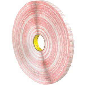 The 1 x 540 yds. 3M™ 476XL Double Sided Tape (6 Rolls/Case) is a large, red and white adhesive tape with a yellow core, featuring a tightly wound circular shape that offers a distinctively layered appearance.