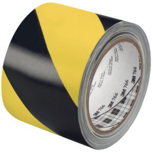 The 3 x 36 yds. Black/Yellow 3M Safety Stripe Warning Tape 766 features diagonal stripes for caution marking. It has a white inner core with logos and is partially unrolled to reveal its adhesive side, making it perfect for safety in various environments.
