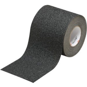 The 6 x 30 Black 3M™ Safety-Walk™ Tape - 710 unfurls, revealing its gritty texture. Designed to enhance grip, it stands out with white edges against a plain white background, ready to boost safety.