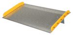 The ramp, with bright yellow side guards and a metal diamond plate surface, resembles the Vestil Aluminum Dock Board Steel Curb 10K 60X36, featuring angled access for vehicles or equipment like models with steel curbs supporting up to 10K.