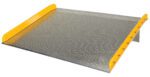 The Vestil Aluminum Dock Board Steel Curb 20K 60X72 features a textured surface, yellow-painted safety edges, and a sturdy steel curb. Its slight elevation allows for seamless gap bridging with a 20K capacity.