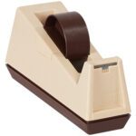 The 3M™ C25 3 Core Table Top Dispenser, in beige and brown, showcases a transparent tape roll embossed with 3M, and features a weighted base and angled body for easy access, ideal for your workspace.