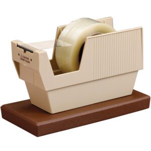 The 3M™ P52W 3 Core Table Top Dispenser features a beige design on a brown base, includes a roll of clear tape, and boasts a ribbed texture. Its visible metal cutting blade has a caution notice, offering both form and function for any tabletop workspace.