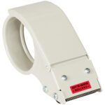 The Tape Logic® 2 Heavy-Duty Strapping Tape Dispenser, in beige, includes a serrated metal blade with a red caution label for cutting tape and a circular handle for easy grip.