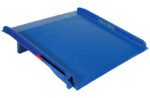 The Vestil 60W X 72L Steel Truck Dockboard is a blue industrial dock plate with a textured, non-slip surface and raised edges. It features yellow text on top, a side metal handle, and is designed with a slight incline for efficient loading/unloading.
