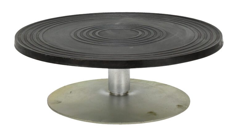 The Vestil Turntable 12 In Diameter 3.875 In H 0.5K features a stylish rotating design with a round, black, grooved top and solid silver base, ideal for bakers who value precision and presentation.