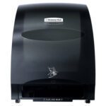 The Kimberly-Clark® Automatic Paper Towel Dispenser - Black (16W x 13H x 10D) features a stylish design with a transparent view, enabling easy towel supply checks. A hand icon assists users for smooth automatic dispensing, promoting seamless hygiene.