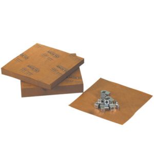 A stack of MH-USA 9 x 12 VCI Paper 30 lb. Sheets (1000/Case) lies next to small metal cubes on a flat brown surface, placed against a plain white backdrop.