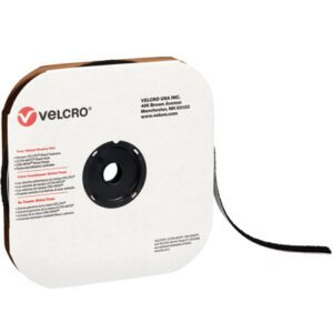 A roll of 5/8 x 75 Black VELCRO® Brand Tape - Hook, with a white and brown cardboard holder featuring the Velcro logo and company details. One end of the tape is extended, ready to use.