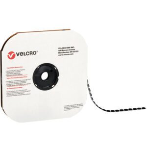 A large spool of black 1/2 VELCRO® Brand Tape with hook fasteners comes in a cardboard dispenser. Ideal for versatile use, it features individual dots with 1440 per case.