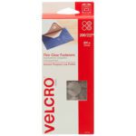 A red and white box of 3/4 Dots - Clear VELCRO® Brand Tape - Combo Pack (200/Case) with each circle 3/4 inch in diameter. The box has a transparent window showing the product and an image of a fastener on fabric.