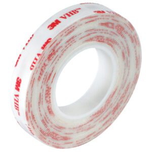 A roll of 1 x 5 yds. White 3M™ 4920 VHB™ Tape features red text on a white backing, is translucent, with the adhesive inward and brand details in red on the outside.