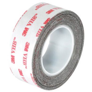 The 1 x 5 yds. White 3M™ 4932 VHB™ Tape features a white backing with red 3M branding, tightly wound to discreetly conceal its strong adhesive side within the case.