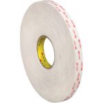 A large roll of 3/4 x 5 yds. White 3M™ 4945 VHB™ Tape stands upright, highlighting its white and red design. The yellow inner core shows text and logos, reflecting the reliability of one roll per case from this renowned brand.