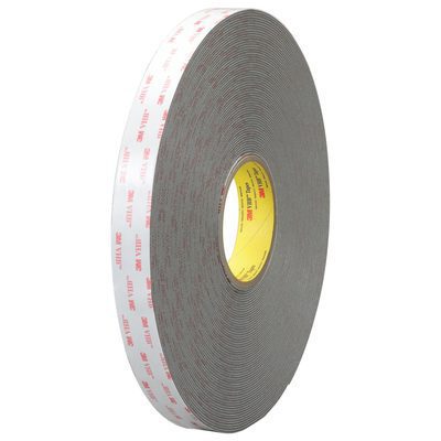 VHB495612R.jpg The gray 1/2 x 5 yds. 3M™ 4956 VHB™ foam tape is a double-sided roll with a white and red backing, featuring a yellow center label emphasizing its layered thickness.