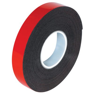 VHB595212R.jpg A 1/2 x 5 yds. roll of dark gray 3M™ 5952 VHB™ Tape, featuring red backing and coiled around a white core, partially unrolls to show its adhesive side for versatile use.