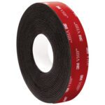 The 1 x 5 yds. Black 3M™ 5962 VHB™ Tape showcases a vivid red backing with 3M VHB branding, contrasting with its white inner core. This adhesive tape comes in a case containing one roll.