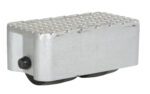 A silver metal foot pedal, similar to the durable Vestil Cast Aluminum Dolly 3000 Lb 8.5L X 4.75W, features a textured grip surface and a round black side knob. Its angled base with two visible black rollers ensures smooth maneuverability for up to 3000 lb loads.
