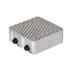 The Vestil Cast Aluminum Dolly 6000 Lb features a textured metal pad with a crisscross diamond pattern, two side knobs, and has an 8.5L X 8.5W rectangular shape with rounded edges, supporting up to 6000 lbs for industrial or mechanical use.