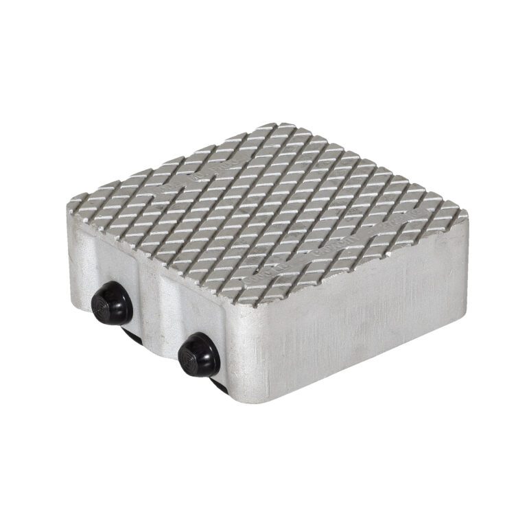 The Vestil Cast Aluminum Dolly 6000 Lb features a textured metal pad with a crisscross diamond pattern, two side knobs, and has an 8.5L X 8.5W rectangular shape with rounded edges, supporting up to 6000 lbs for industrial or mechanical use.