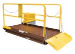 The Vestil safety cage platform for forklifts features railings, chains on all sides, a metal floor, and a ramp. Ideal for elevated tasks, it pairs excellently with the Prem Truck Scissor Dock Lift 5K 8X8 Ft.