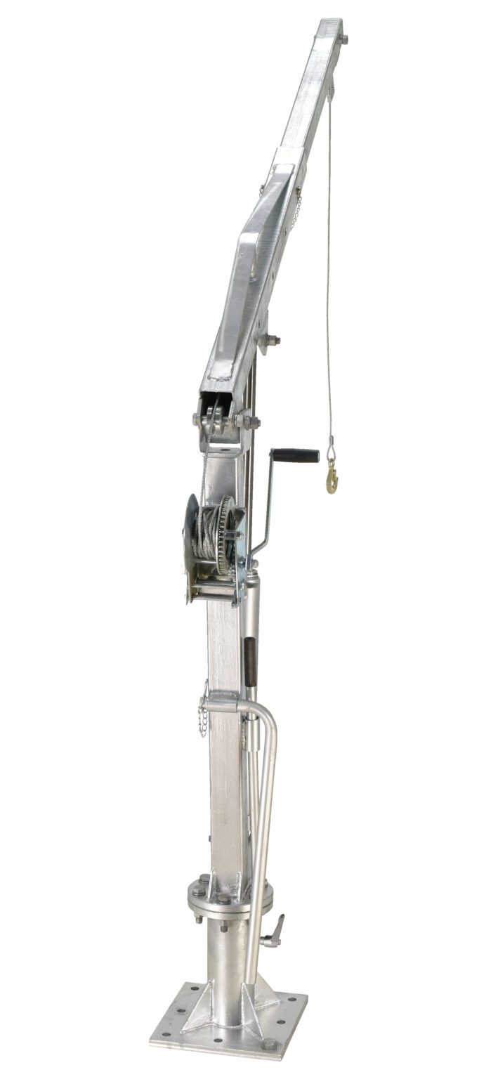 The Vestil Winch Truck Jib Crane 1K Extended Galv is a sturdy, metal crane with an extended arm, hand winch, and pulley on a square base, perfect for lifting and transporting heavy loads in industrial or construction environments.
