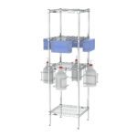 The Metro CR181863-PPET PPE Rack is a tall, metal storage unit with wire shelves, holding a blue crate on one shelf and four white gallon containers in metal holders below, offering versatile storage solutions.