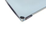 The close-up shows the textured gray surface and metal edge of an 18 x 36 MetroMax i MX1836F Plastic Industrial Shelf, featuring a black and blue MAX-7 label. Its sturdy build suggests it is part of larger machinery.