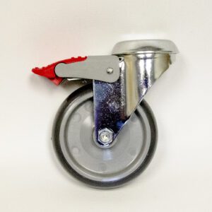 A single swiveling caster wheel with a metal frame and a red brake lever is displayed against a plain white background. Perfect for high-quality laboratory furniture, the wheel is made of gray rubber with a metallic mount and black edges.