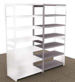 The Aurora Quik-Lok Shelving Open Storage Add-On Unit features a modern two-tone design with 6 openings. The left side has white shelves and frame, while the right side offers gray shelves and a matching frame. It stands 76 tall and is elegantly set on a diagonally striped carpeted floor.