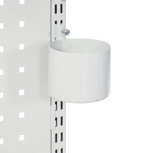 A metal cup holder is attached to a perforated white panel. The holder is cylindrical, and secured with a screw to the panel. The panel has a grid of square holes, and the cup holder is positioned near the edge.