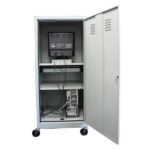 The Vulcan VI FULL REAR DOOR CAB TX GRY metal storage cabinet, mounted on wheels, is shown with open doors revealing a monitor on the top shelf and a computer tower below, while cables connect the electronics, leaving most of the interior empty.