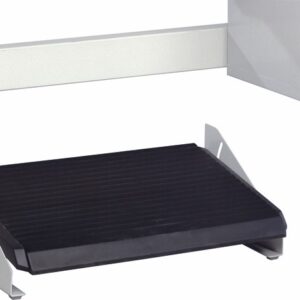 A black and silver ergonomic footrest with an inclined surface is positioned on a light-colored floor. The footrest features a ridged texture on its top surface and has metal supports on the sides.
