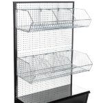 The Vulcan Wire Basket Display Rack includes a sleek black pegboard stand with two shelves for organizing merchandise in 12 x 24 metal wire baskets (Vulcan WIRE BASKET 12 X 24 OEB, 8 per carton), featuring a solid black panel base for stability and style in any retail setting.