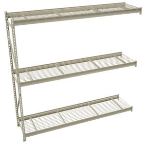 A beige metal shelving unit with three wide wire grid shelves. The shelves are evenly spaced and supported by vertical metal beams with holes for adjustable heights. The unit is angled diagonally against a plain white background.