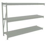 A gray, industrial metal shelving unit with three wide, evenly spaced shelves, seen at an angle. The shelves feature slatted surfaces and appear sturdy, suitable for storage in a warehouse or garage.