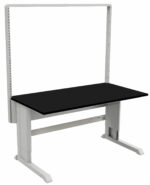 A black workbench with a sturdy metal frame is shown, ideal for laboratories. It features a height-adjustable tabletop and vertical back support with perforated slots for accessories or storage units, blending modern industrial design with functionality akin to stainless steel gowning benches.