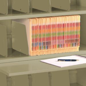 A beige filing cabinet with multiple shelves. One shelf holds a row of multicolored file folders. Below, a pull-out surface supports a notepad and a pen. The cabinet features several vertical dividers for organization.