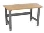 A sturdy workbench with a wooden tabletop and gray metal legs. The surface is rectangular, and the legs have adjustable supports, suitable for various workshop tasks.
