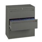 A gray metal filing cabinet with two drawers. The top drawer is closed and the bottom drawer is partially open, revealing blue hanging file folders inside. A lock with a key is visible on the top drawer.