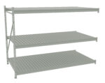 Metal shelving unit with three wide, horizontal shelves. The structure has vertical supports on the left and is open on all sides. The shelves are evenly spaced with a flat, slatted design. The shelving is light gray.