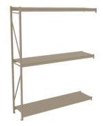 A beige metal shelving unit with three levels, featuring slatted surfaces. The unit is designed for heavy-duty storage, supported by vertical frames and cross braces on the left side.