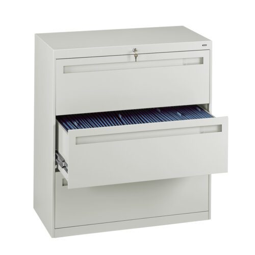 A white metal filing cabinet with two drawers. The top drawer is closed and locked, while the bottom drawer is partially open, revealing organized files. The cabinet is set against a white background.
