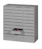 A gray metal storage cabinet with multiple small drawers, one of which is open, revealing stationery items inside. The cabinet features a uniform, industrial design with handle pulls on each drawer.