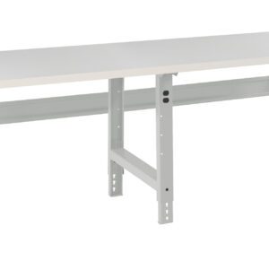 A long, rectangular white workbench with adjustable metal legs and support beams. The bench top has a smooth surface, and the legs have holes for height adjustment. The design is simple and functional, suitable for a workshop or garage.