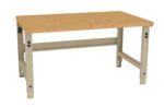 A sturdy wooden workbench with a light brown tabletop and beige metal legs, designed for industrial or workshop use. The table features adjustable height settings visible on the legs.