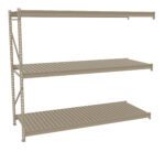A three-tiered, beige metal shelving unit with slatted surfaces on each shelf. The shelves are evenly spaced, and the unit is positioned against a plain white background.